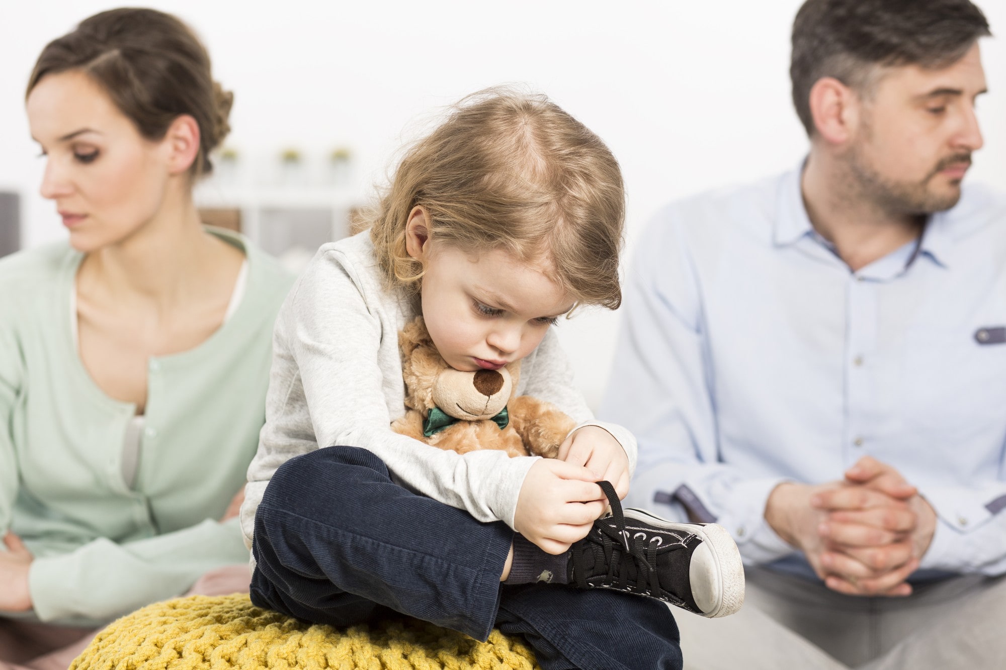 Gloomy Young Family With A Sad Little Boy