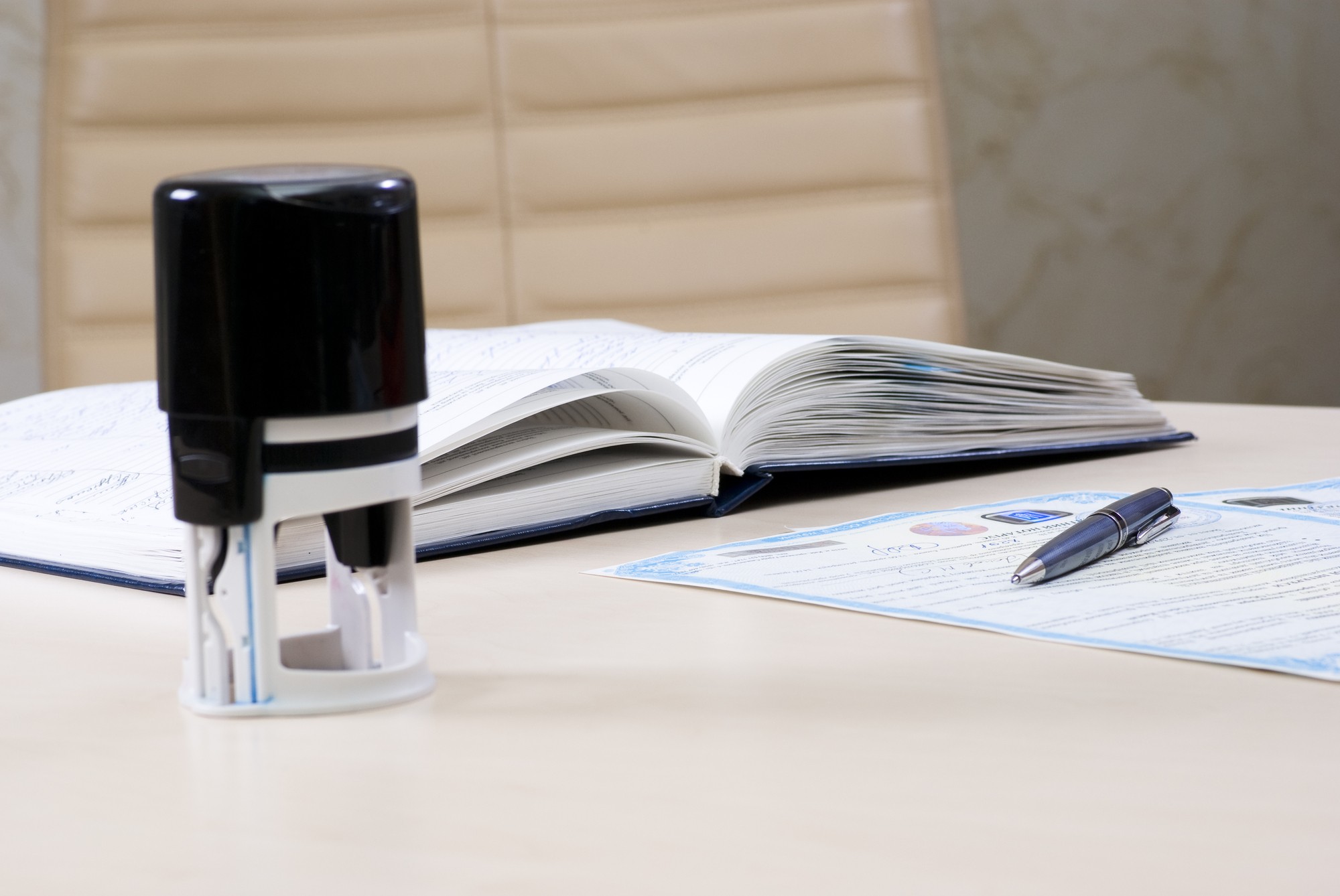 Stamp And Notary's Book On The Table And The Document